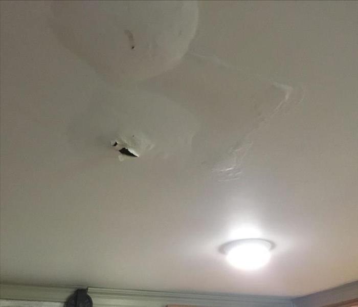 Water damaged ceiling with water pockets/bubbles