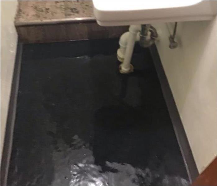 Bathroom floor covered in water