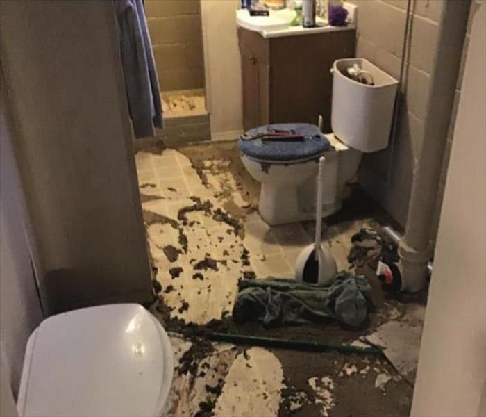 Bathroom with mud-like water on floor