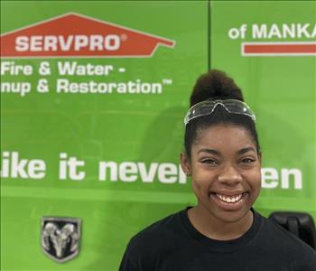 SERVPRO employee in front of green truck