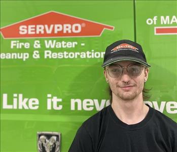 SERVPRO employee in front of green truck