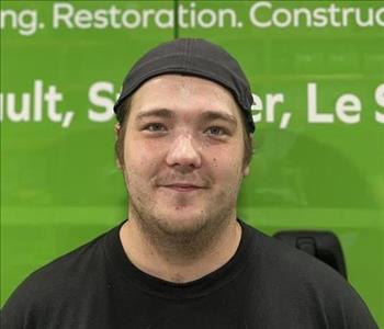 Employee in front of green truck