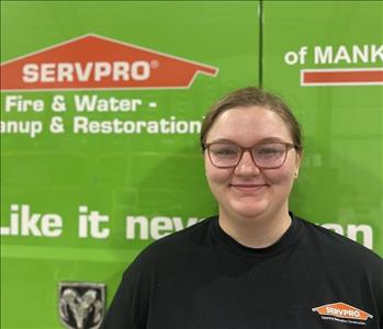 SERVPRO employee in front of green truck