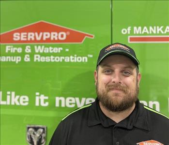 SERVPRO employee in front of green truck