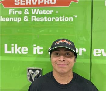 SERVPRO employee in front of green truck