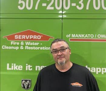 SERVPRO employee in front of green truck