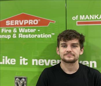 SERVPRO employee in front of green truck